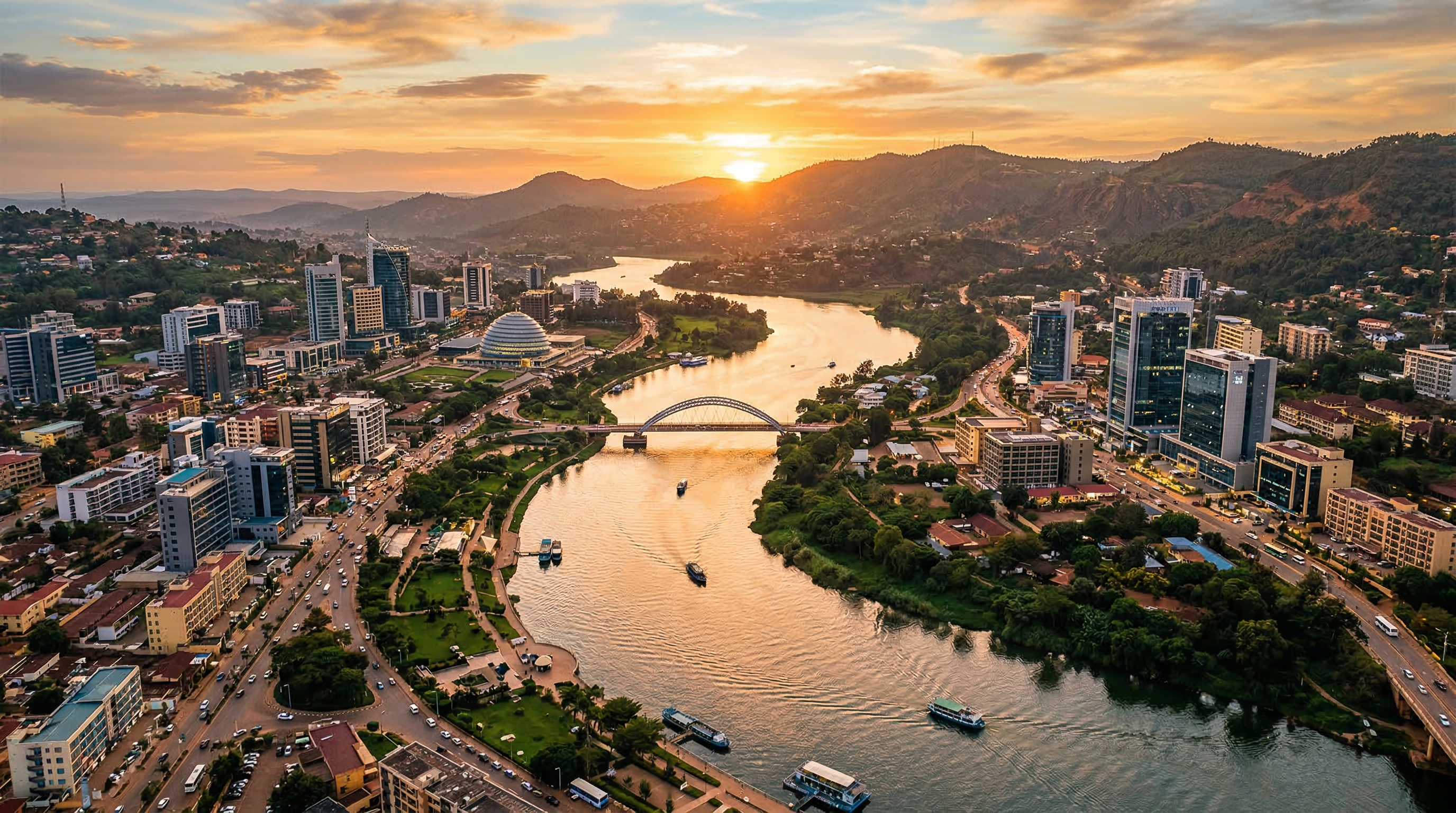 Modern African city with river winding through lush landscape at golden hour